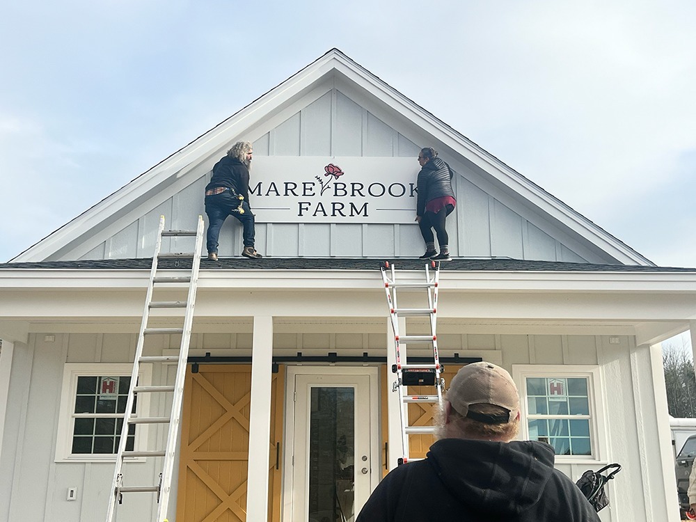 Hanging the sign at Mare brook Farm