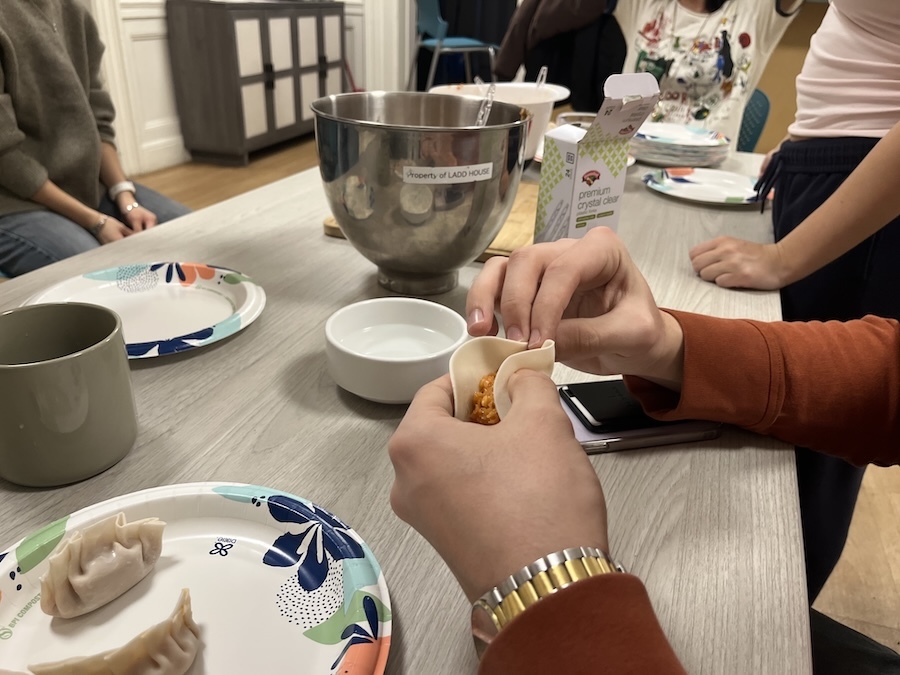 student folds a mandu