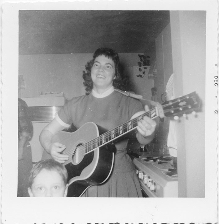 Ella Hanshaw playing a 1955 Gibson Country Western acoustic in her kitchen in Brunswick, Ohio, in 1961.