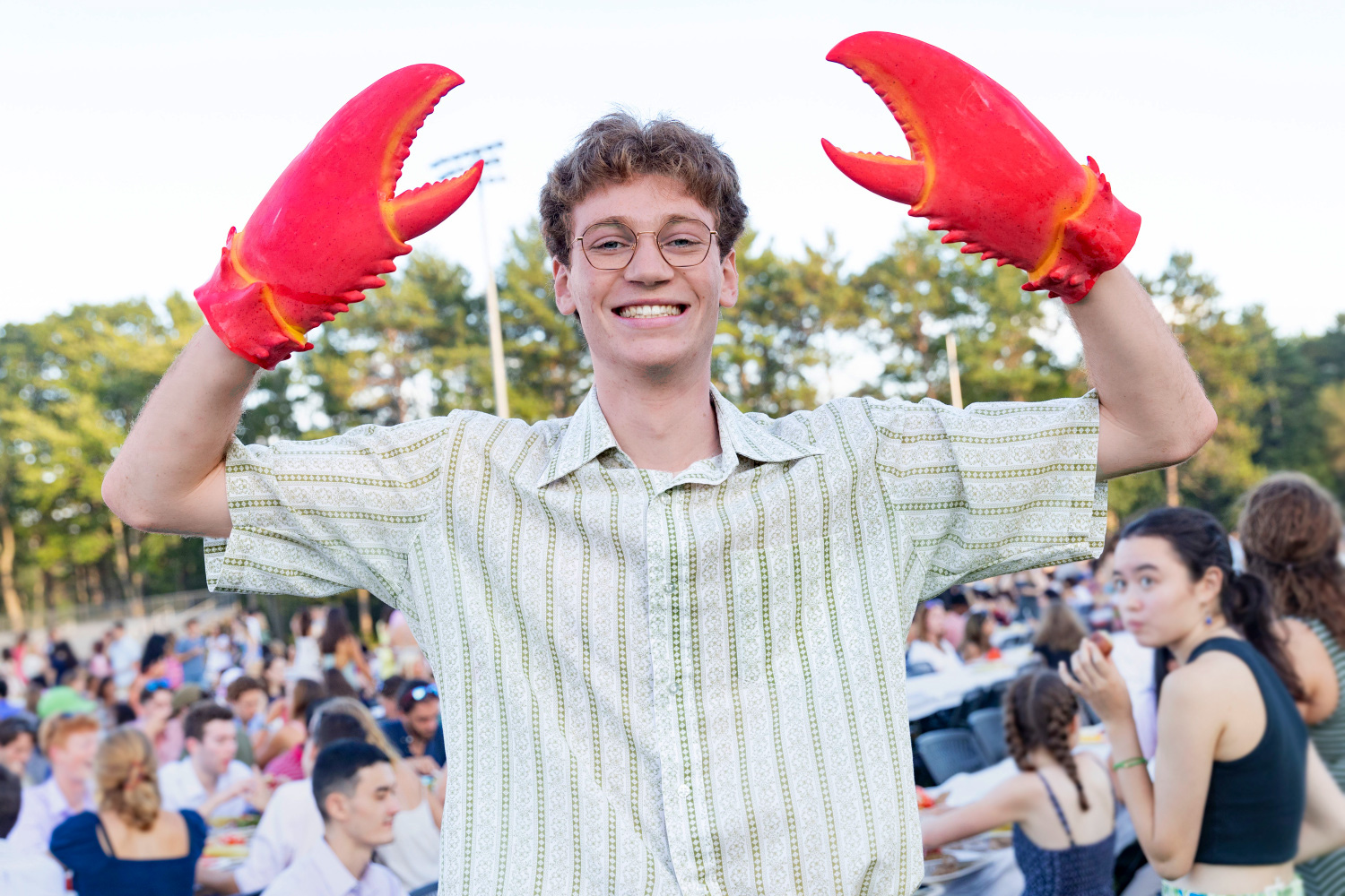 A Bowdoin student wearing lobster claws.