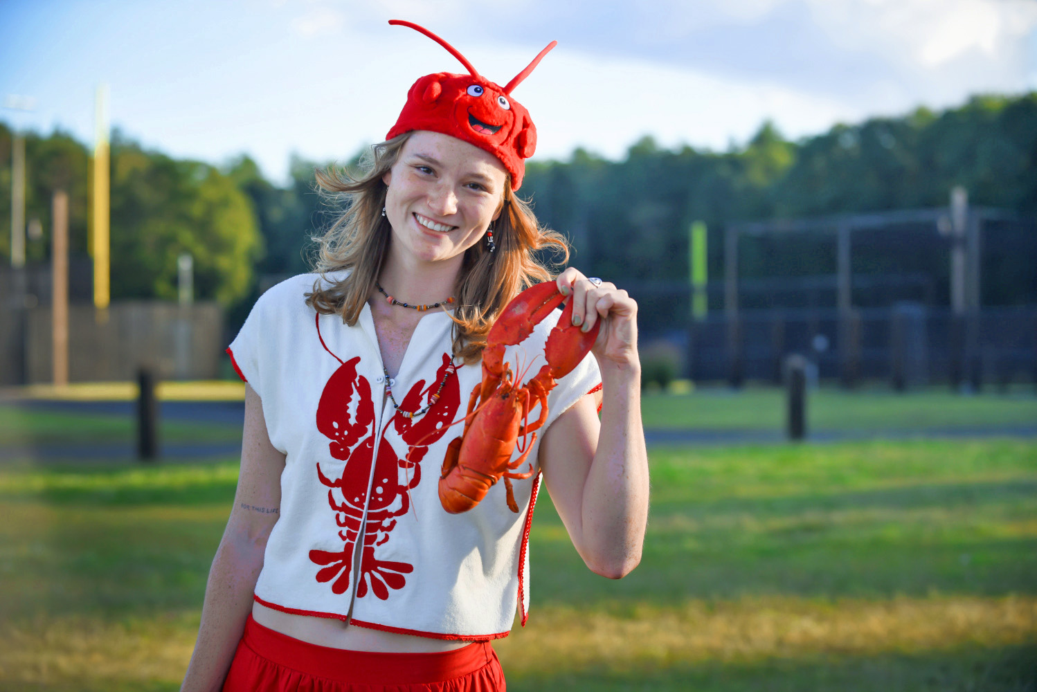 A Bowdoin student wearing a lobster shirt and hat.