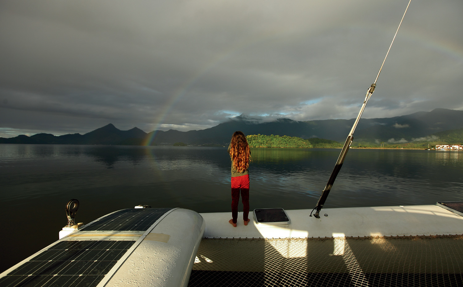 Tormentina, twelve, takes in the sky after some rain in December 2020 at Ilha Grande Bay, Rio de Janeiro, Brazil.