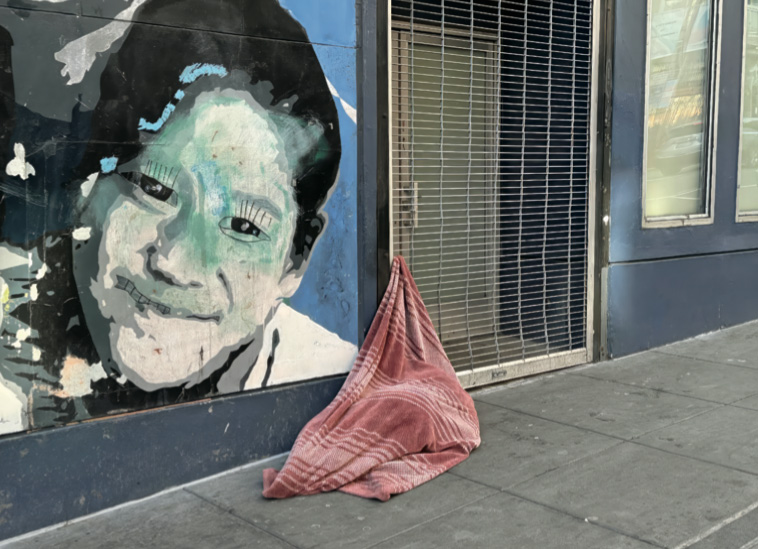 A person asleep on the streets of San Francisco