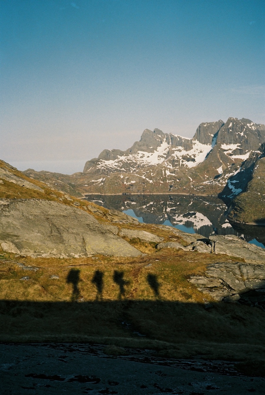Nellie and hiking companions in Norway, looking at snow-covered mountains