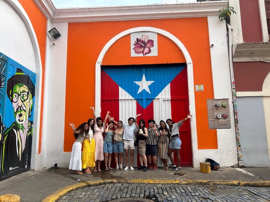 student stand in front of a colorful mural in Puerto Rico