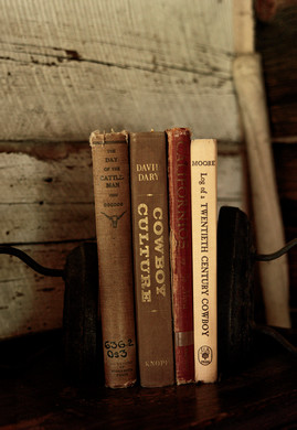 A selection of books in Hibbard’s office, a spring house constructed with logs from his family’s ranch. Photograph by Rebecca Stumpf