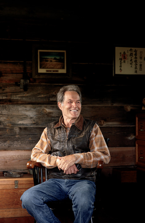Whit Hibbard sits in chair posing for photo