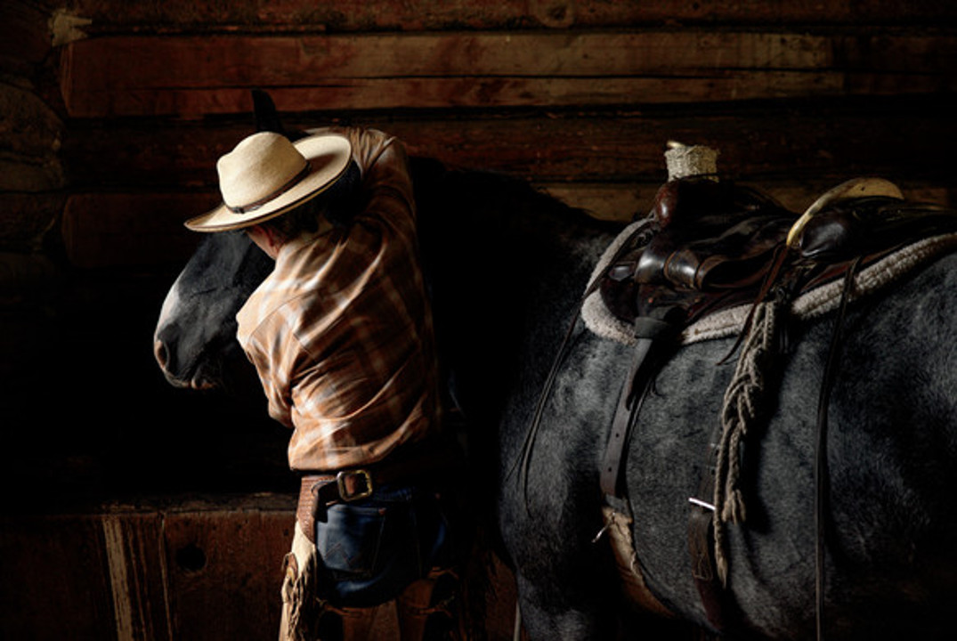 Hibbard saddles up Teddy, who was caught as a wild horse in Theodore Roosevelt National Park. Photograph by Rebecca Stumpf
