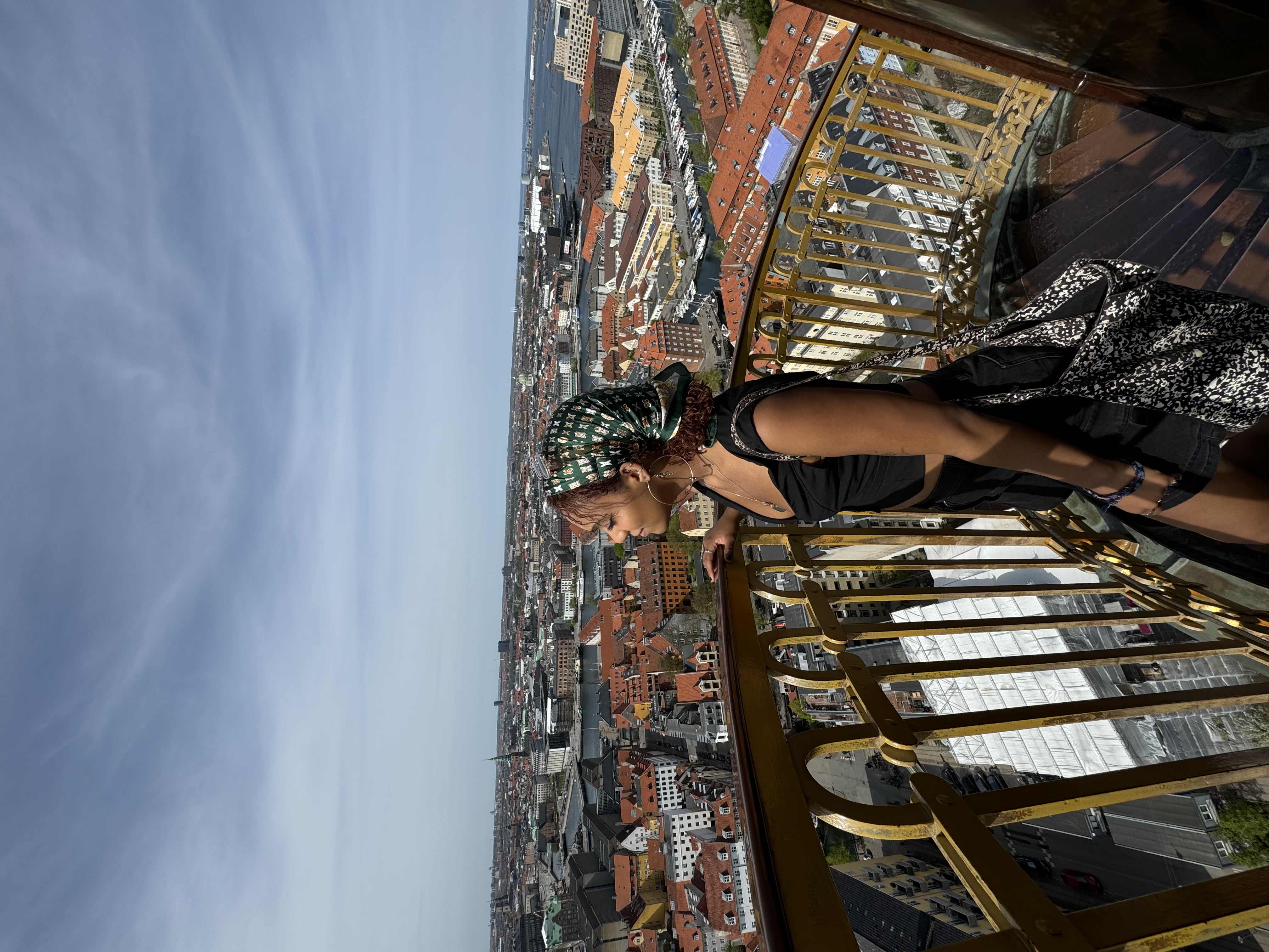 Student overlooking Copenhagen rooftops.