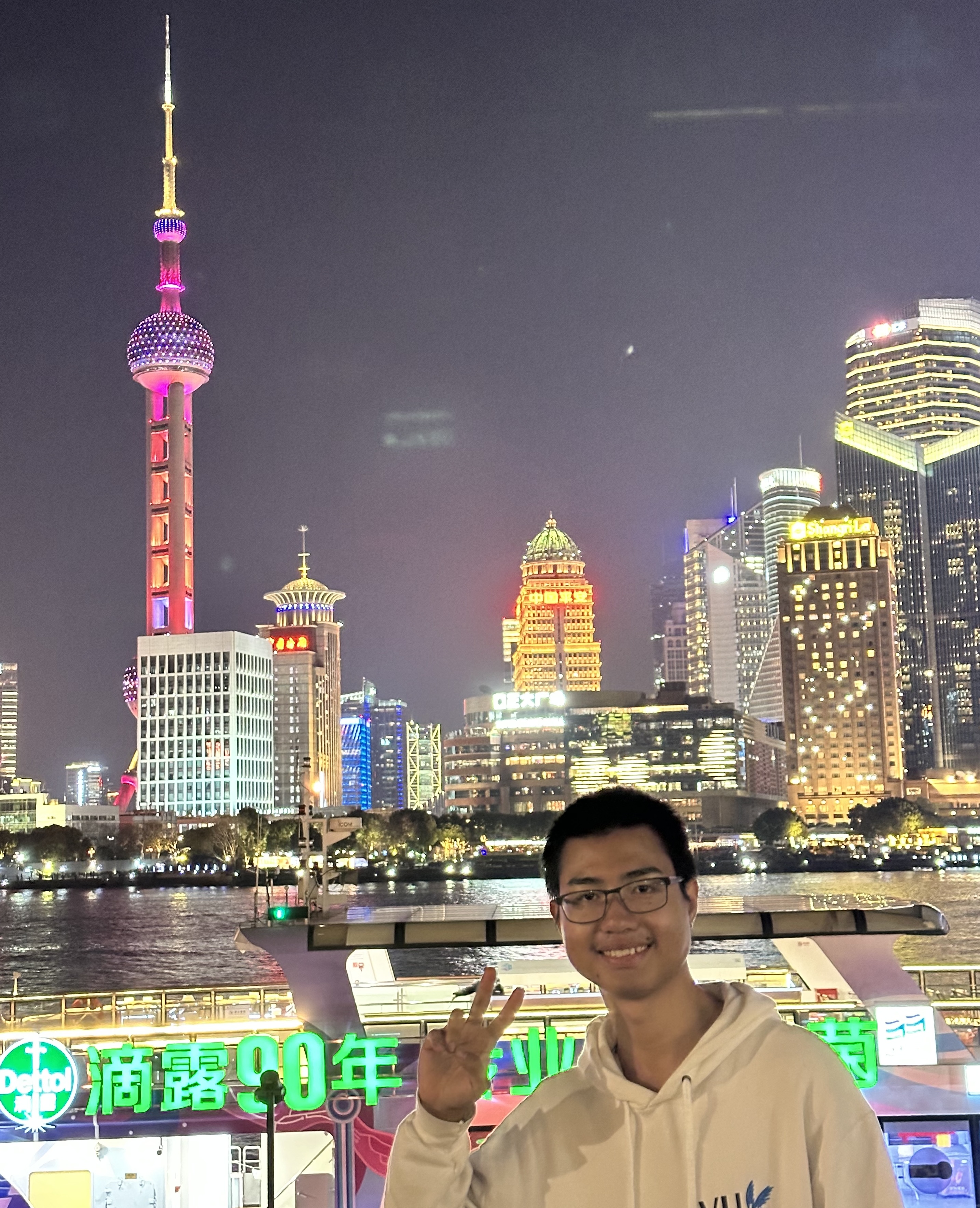 Student in front of urban skyline at night.