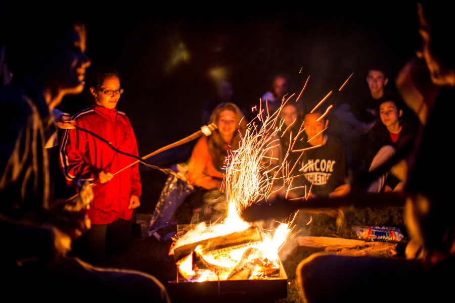 Students around a campfire.