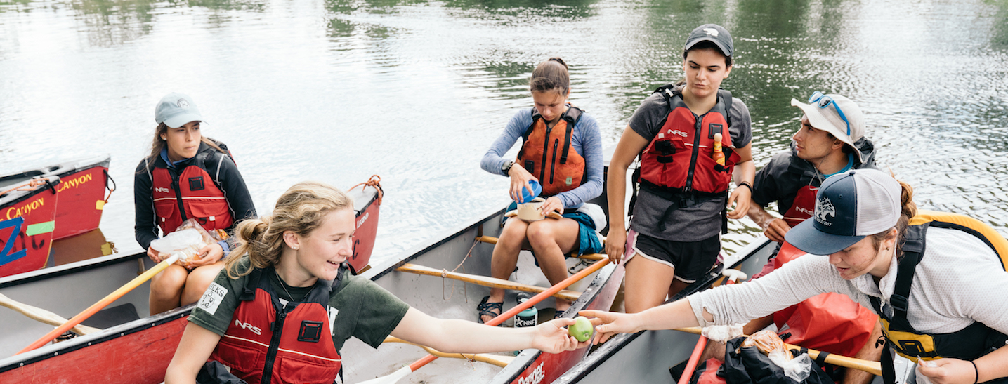 students in canoes having fun.