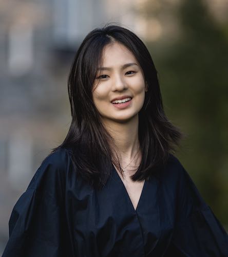 Photo of Jane Wang smiling at the camera, in a black dress