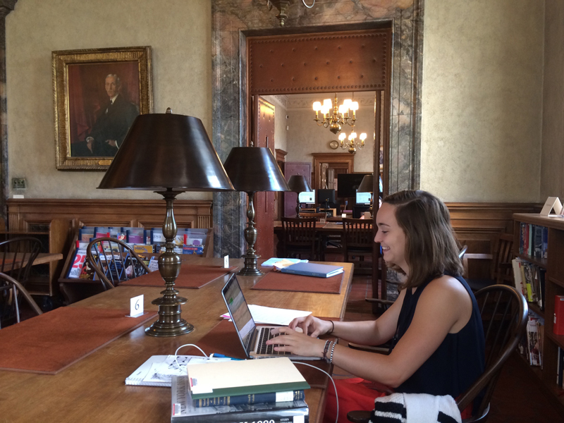 Eliza Goodpasture on her laptop in the library.