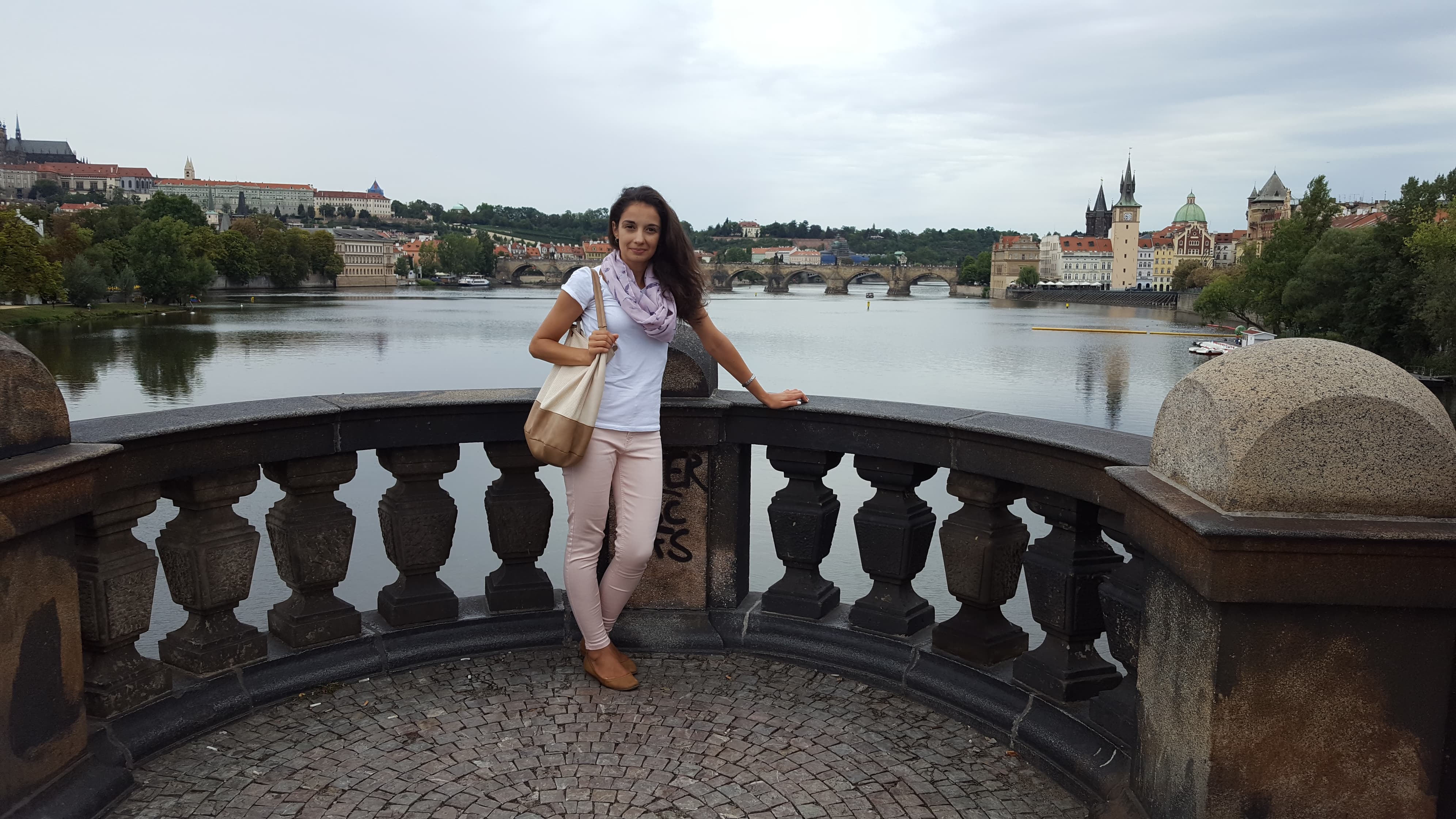 Mira Nikolova posing in front of river cityscape in Russia.