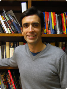 michael franz standing by bookshelf