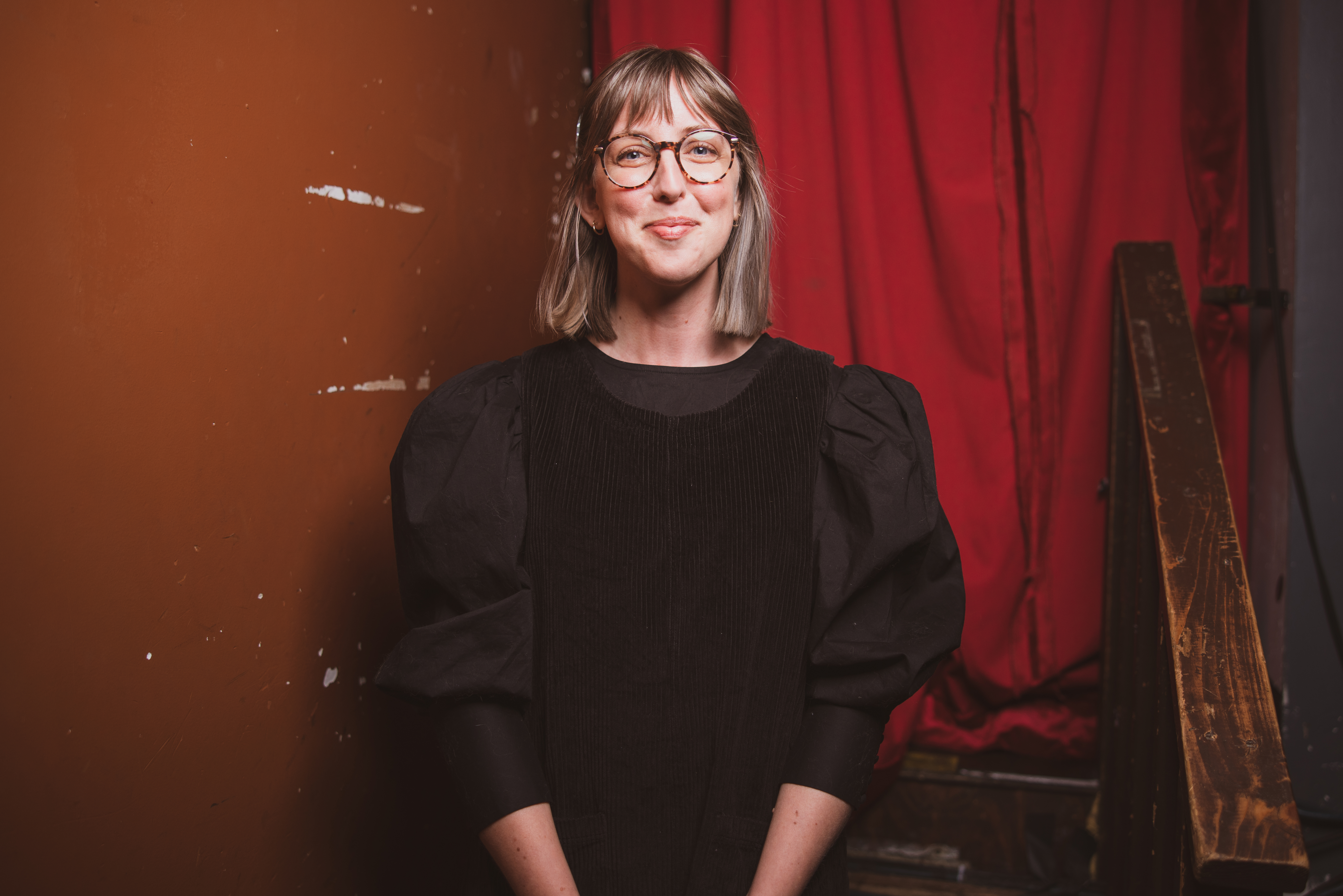 photo of Allie Kokesh in black clothes and wearing glasses