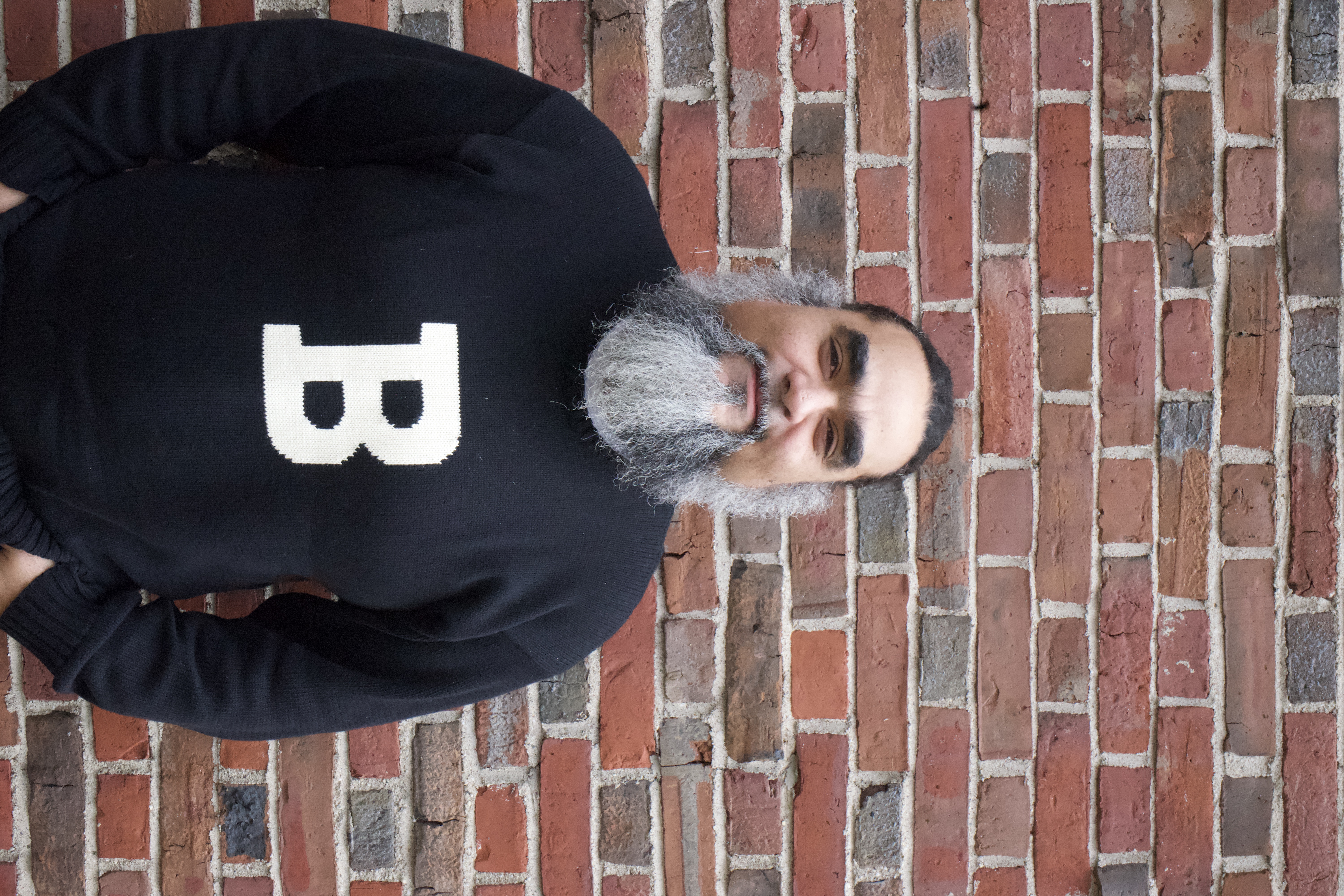 Mo standing in front of red brick wall