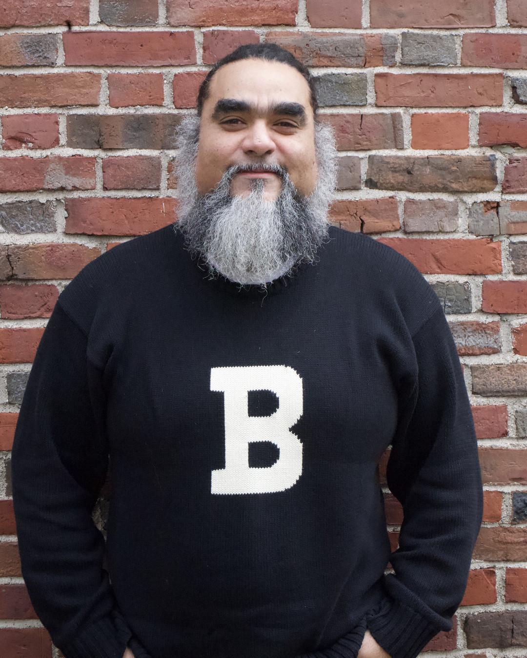 Mo standing in front of red brick wall