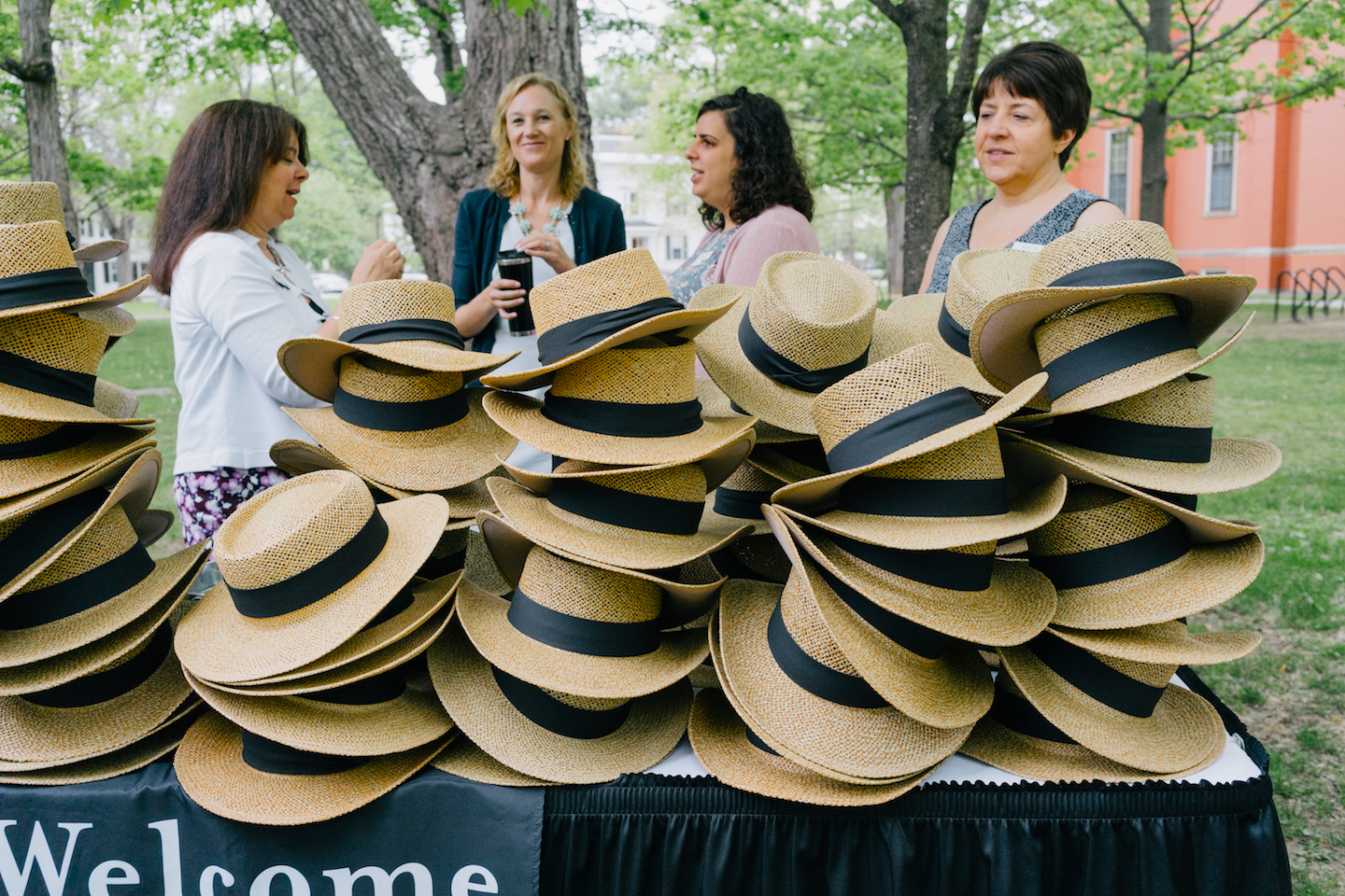 Staff distribute Bowdoin alumni hats.