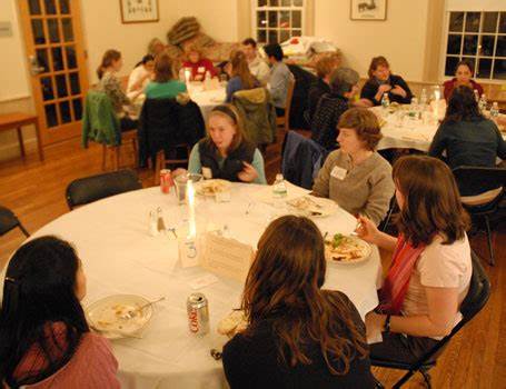 Five individuals talking around a table