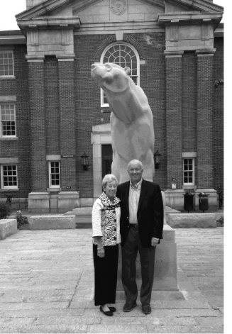 Photo of Dave Stevenson with wif in front of polar bear statue