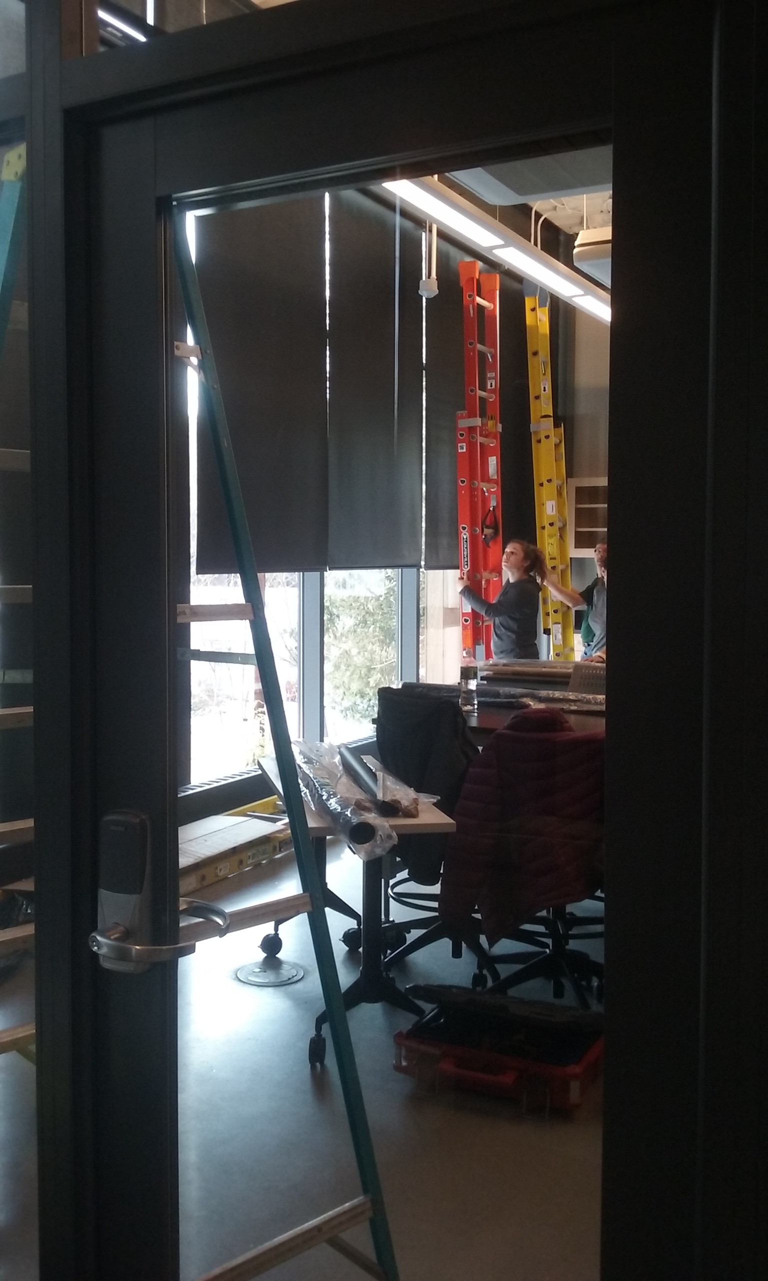 Automated window shades being installed in one of the Roux Center's classrooms
