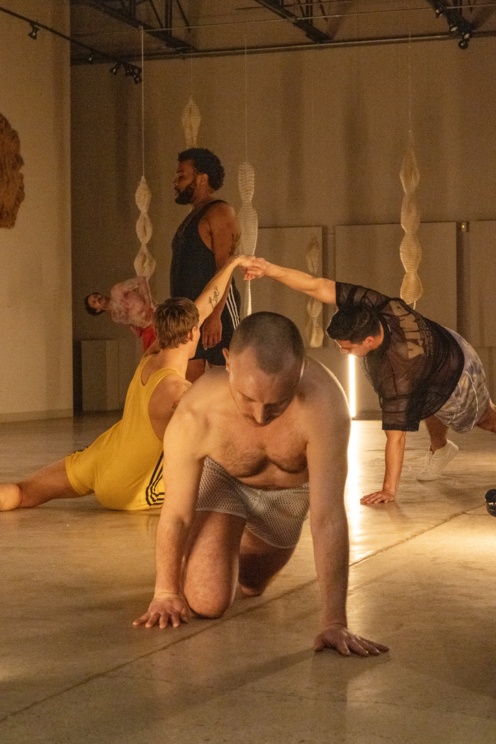 Group of dancers on stage, each doing a different pose.